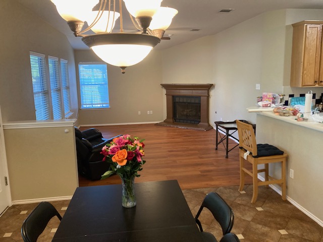 4816 Norman Trail Austin, TX 78749 - Photo 10 of 19 a living room with furniture flowers and a chandelier
