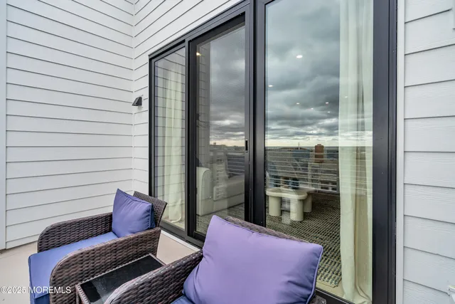 a view of a balcony with chairs