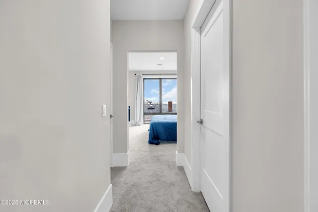 a view of a hallway with wooden floor and a cabinet