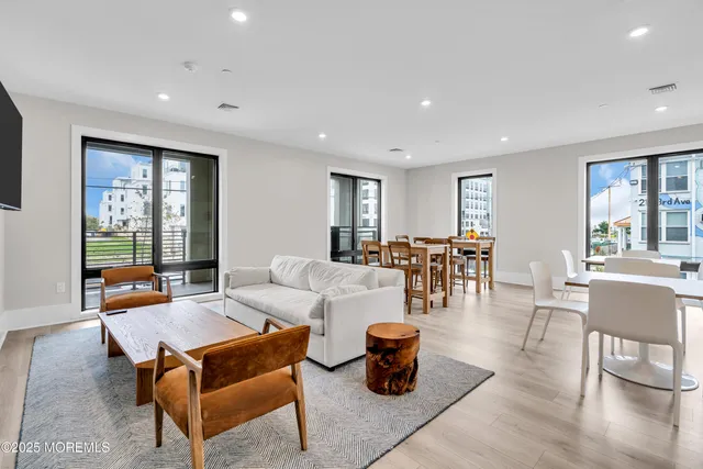 a living room with furniture a table and a large window