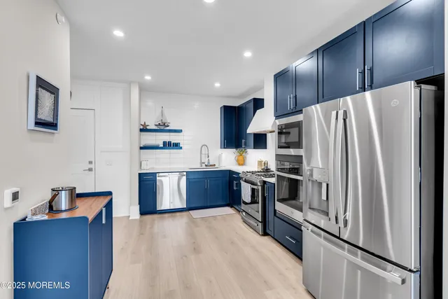 a kitchen with stainless steel appliances a refrigerator stove microwave and sink