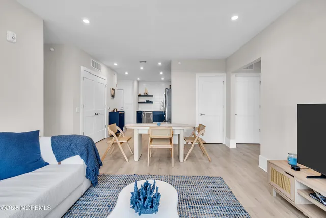 a living room with furniture a rug and a flat screen tv