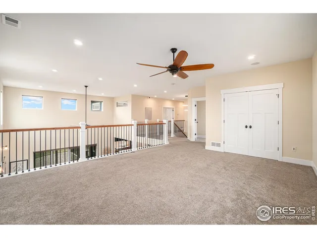 a view of a livingroom with a ceiling fan and window