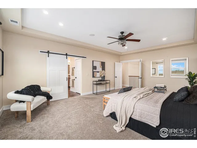 a bedroom with a bed and a ceiling fan