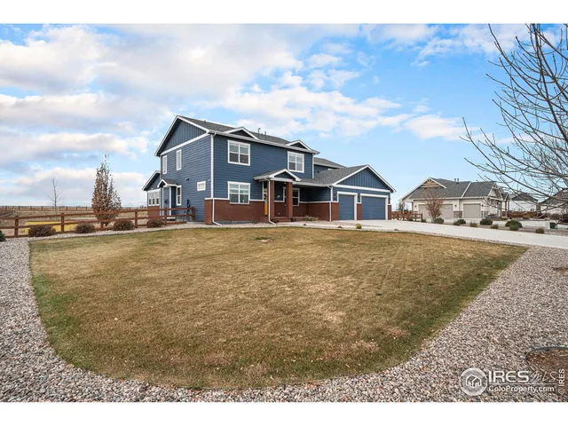a view of a yard and front view of a house