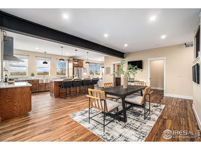 a living room with dining room and wooden floor