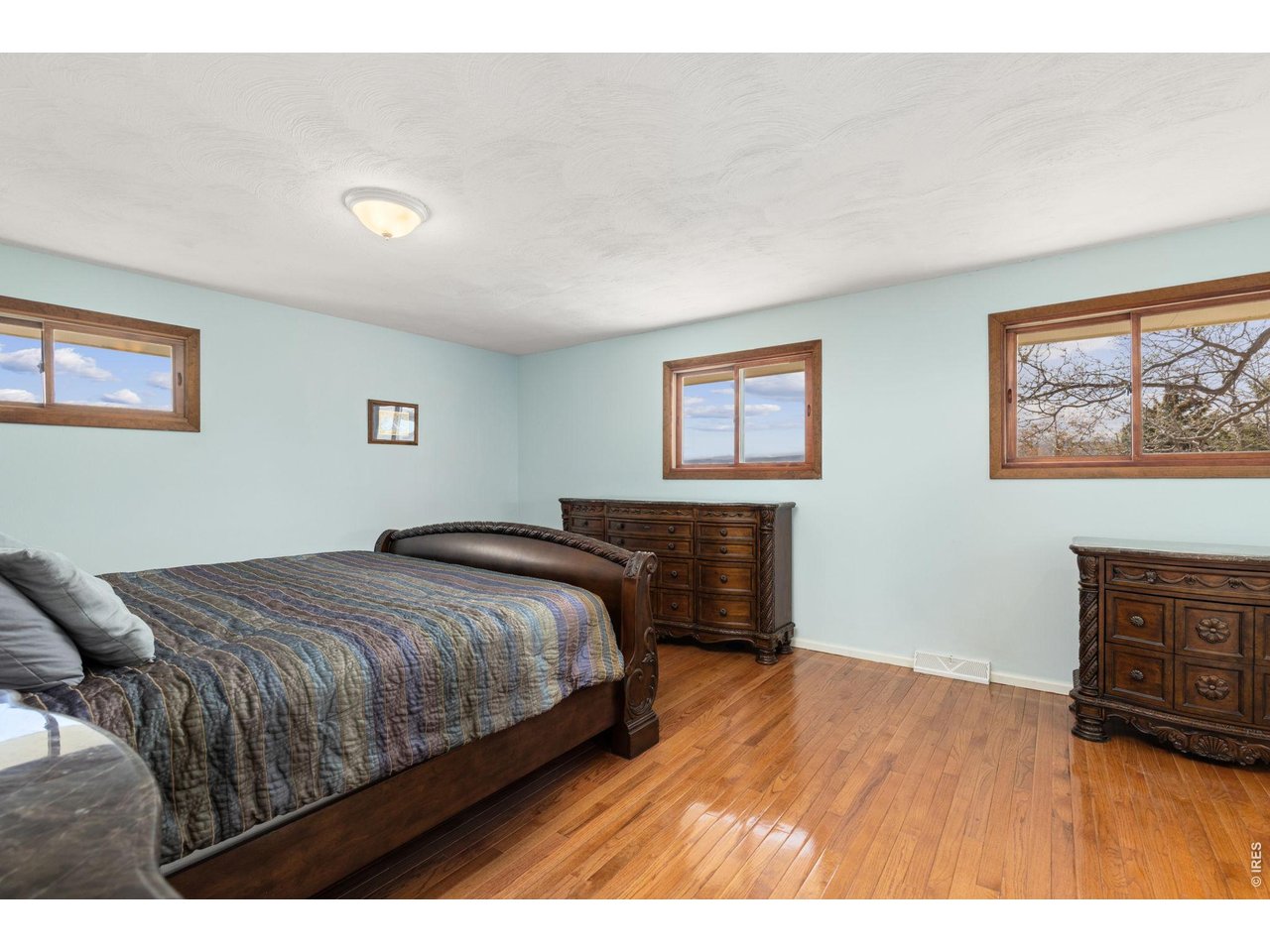218 Bothun Road Berthoud, CO 80513 - Photo 11 of 35 Primary Bedroom on main level with hardwood floors.