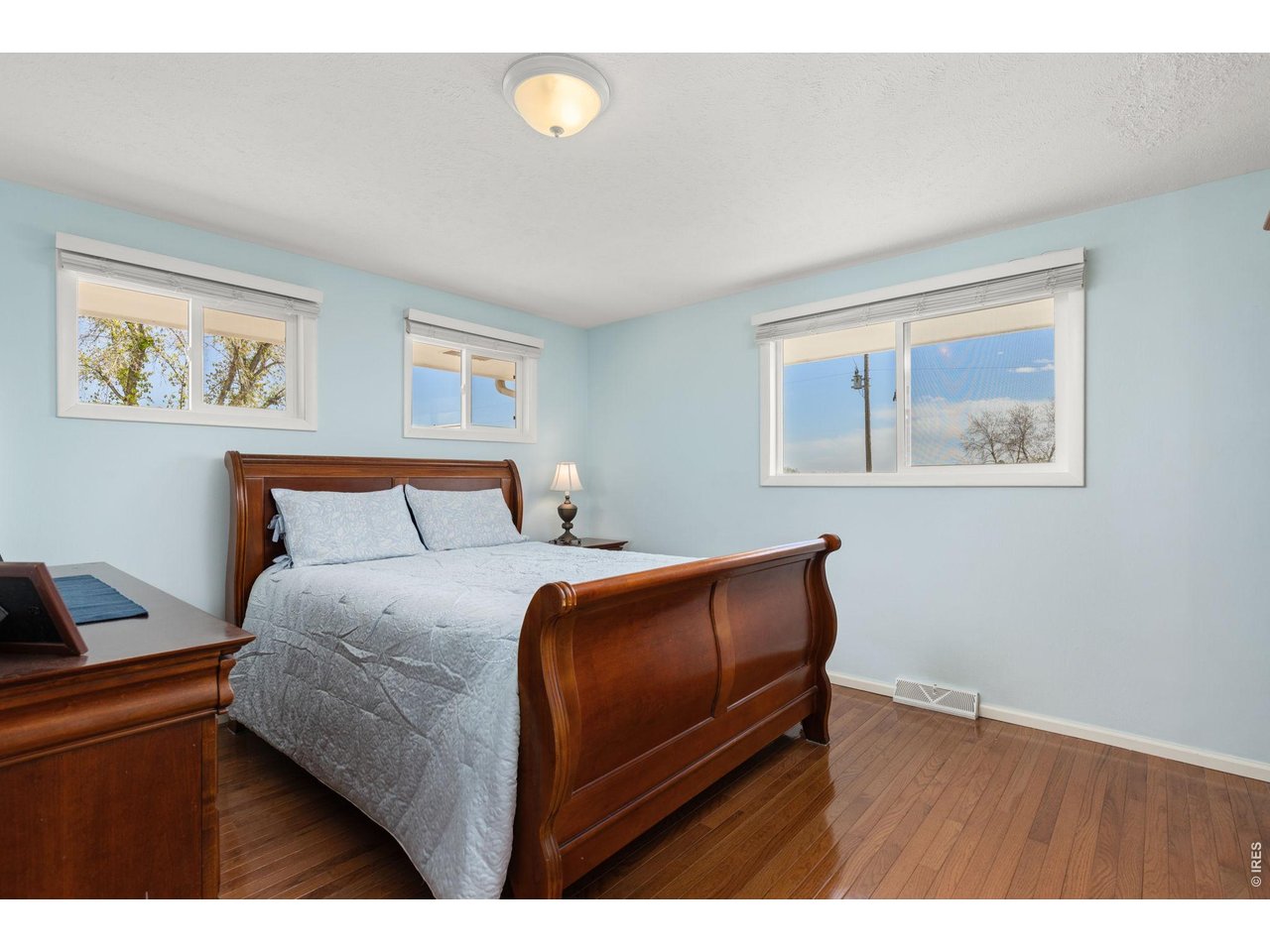 218 Bothun Road Berthoud, CO 80513 - Photo 12 of 35 Guest Bedroom on main level with hardwood floors. (non-conforming)