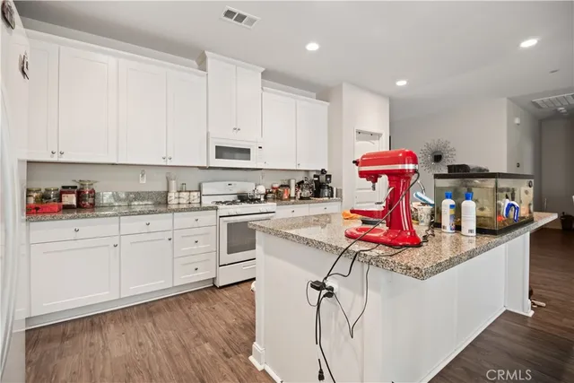a kitchen with a white cabinets and appliances