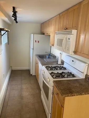 a kitchen with a stove and a refrigerator