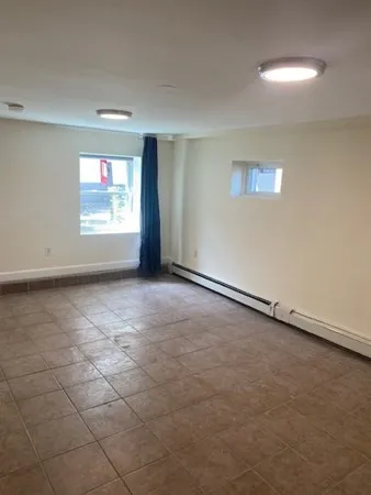 an empty room with a empty space and window