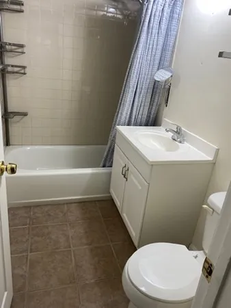 a bathroom with a sink a toilet a mirror and shower