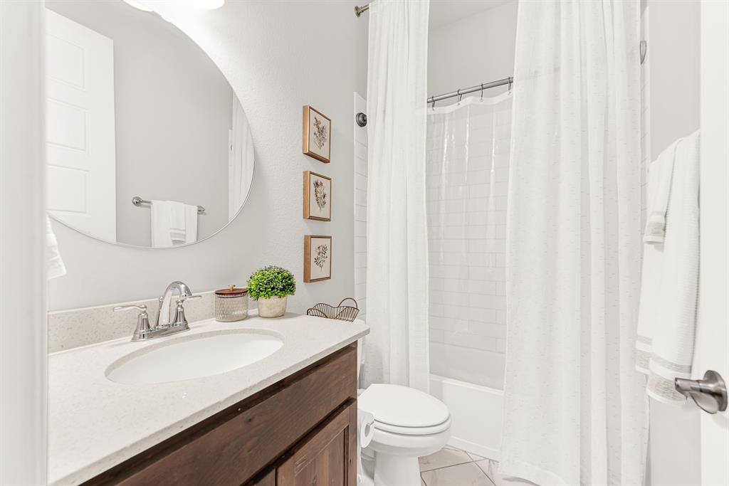 6404 Trezevant Street Rowlett, TX 75089 - Photo 24 of 30 a bathroom with a sink toilet and shower