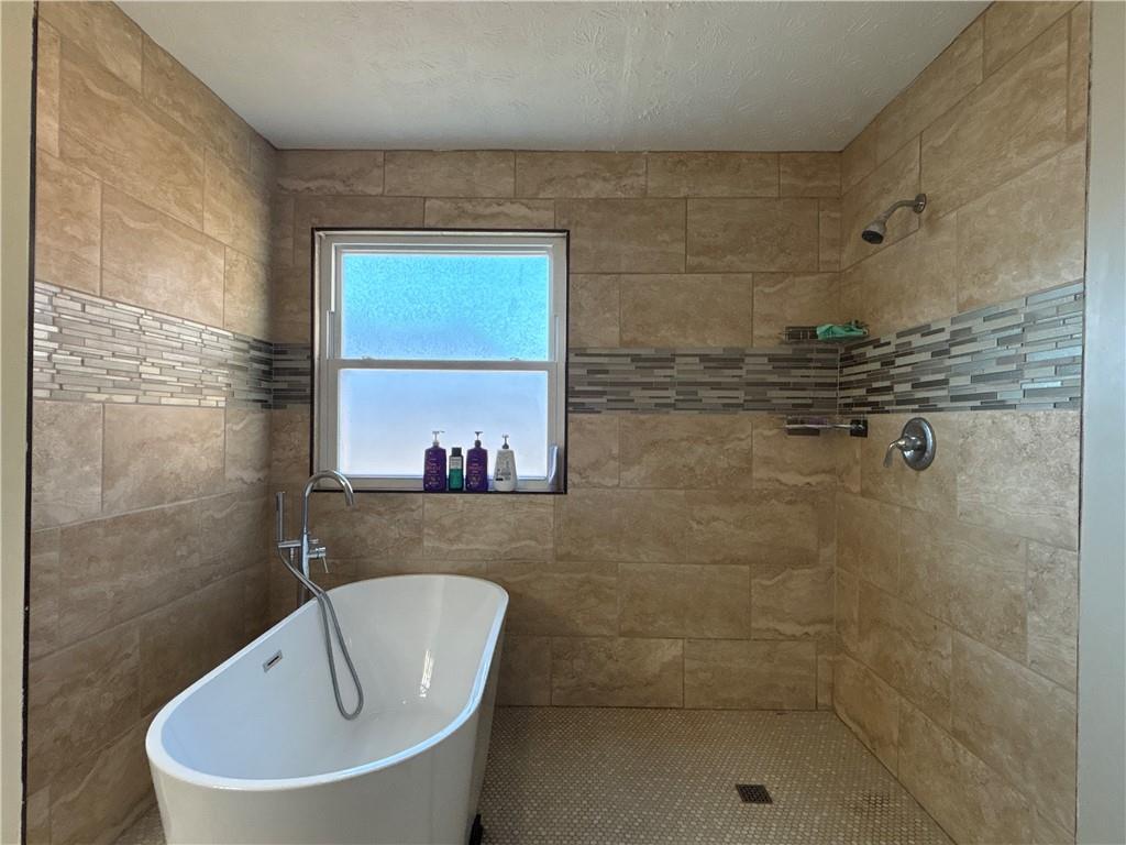 3720 Scotland Lane Southwest Snellville, GA 30039 - Photo 19 of 40 a bathroom with a bathtub and shower