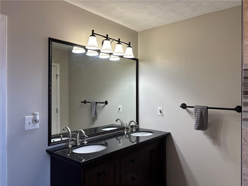 3720 Scotland Lane Southwest Snellville, GA 30039 - Photo 21 of 40 a bathroom with a sink and a mirror