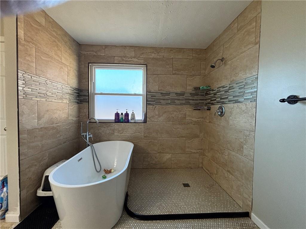 3720 Scotland Lane Southwest Snellville, GA 30039 - Photo 22 of 40 a bathroom with a bathtub and shower