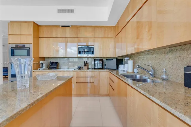 a kitchen with stainless steel appliances granite countertop a sink and cabinets