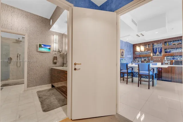 a view of a livingroom with furniture and a book shelf