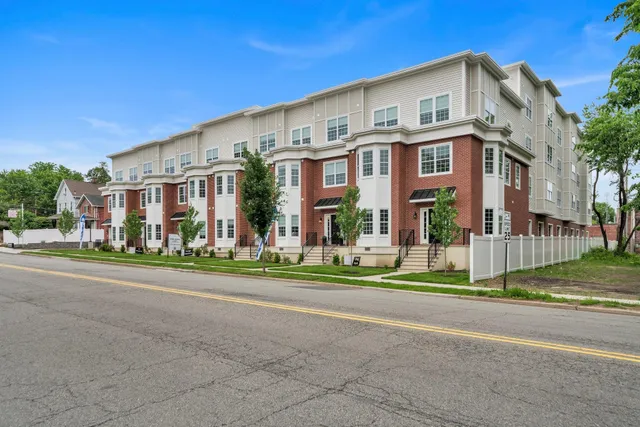 a front view of residential houses with street