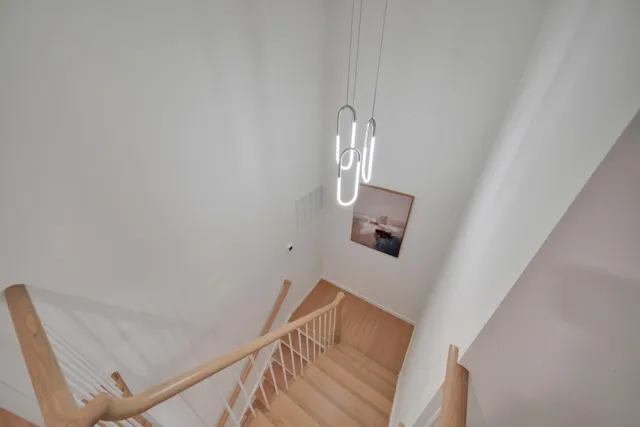 a bedroom with a bed a couch and a window