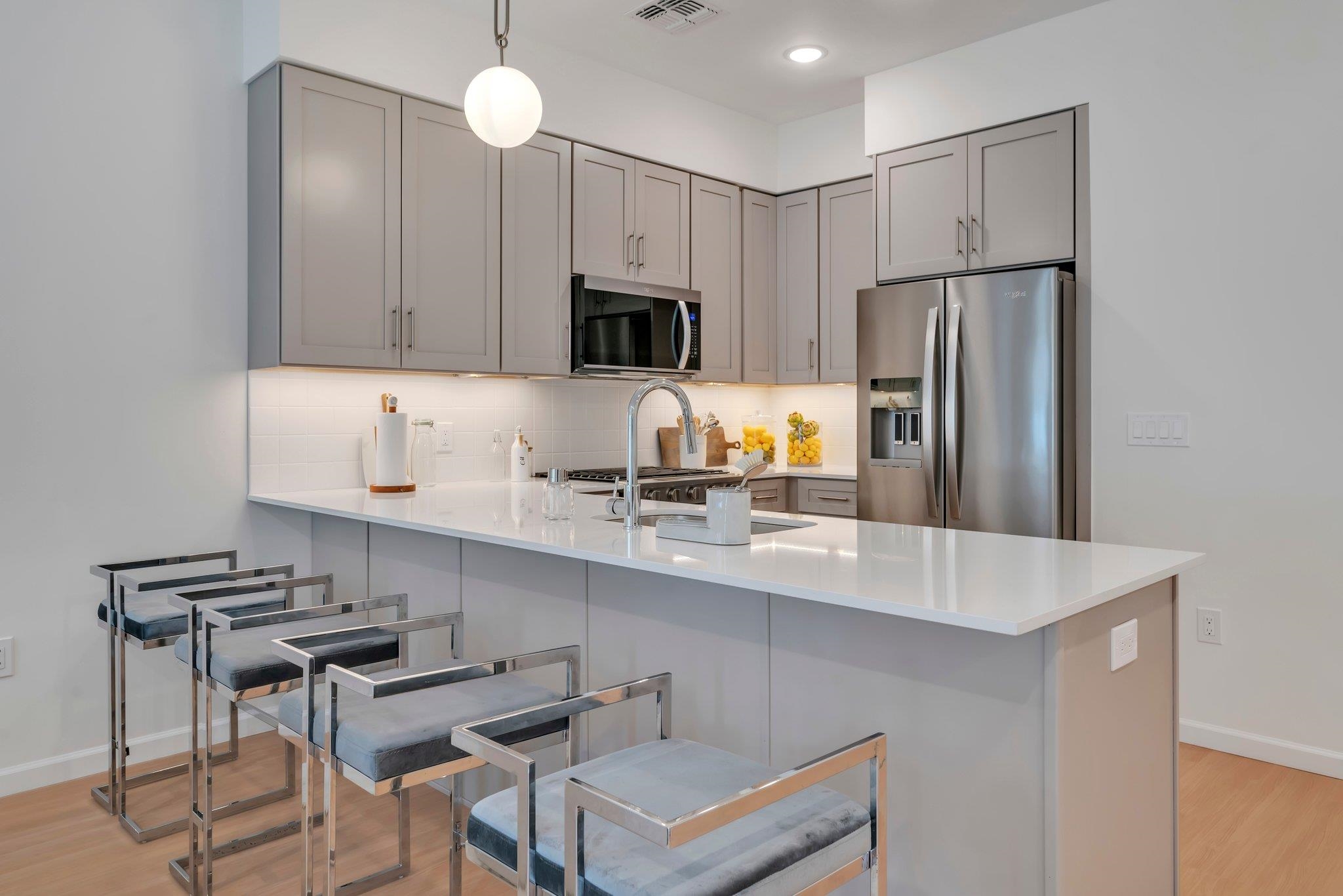 70 Ridgedale Avenue, Unit 103 Morristown, NJ 07960 - Photo 4 of 50 a kitchen with stainless steel appliances a sink a stove a refrigerator cabinets and chairs