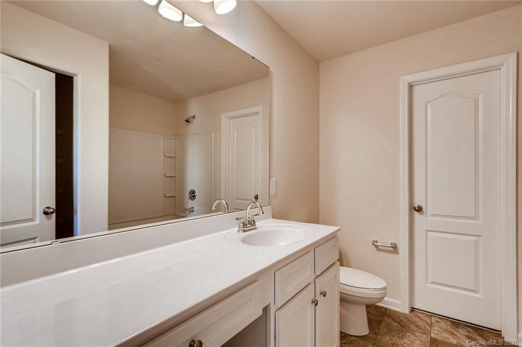 3421 Ellingford Road Charlotte, NC 28214 - Photo 12 of 16 a bathroom with a sink a toilet and a shower