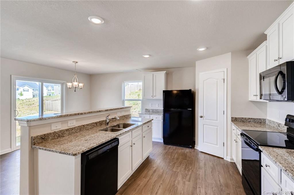 3421 Ellingford Road Charlotte, NC 28214 - Photo 5 of 16 a kitchen with a sink stove and refrigerator