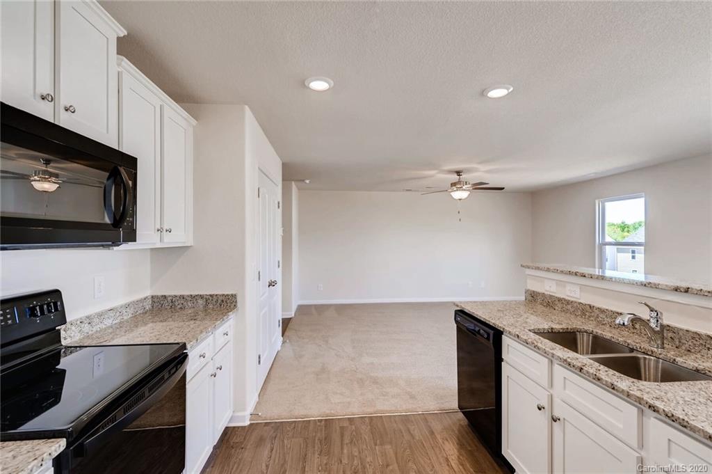3421 Ellingford Road Charlotte, NC 28214 - Photo 6 of 16 a kitchen with granite countertop a sink stainless steel appliances and cabinets