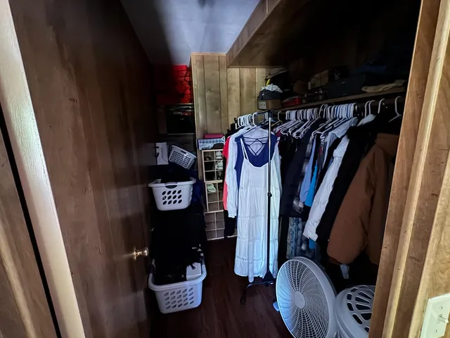 a view of walk in closet with clothes and shoes