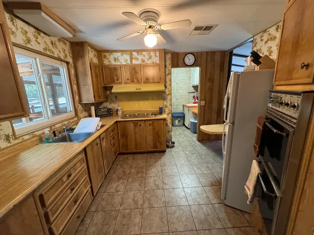 a view of a balcony with chairs and wooden floor