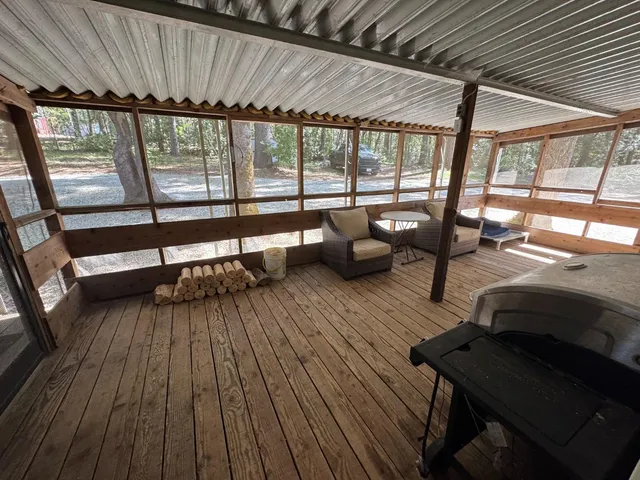 a living room with furniture floor to ceiling window and wooden floor