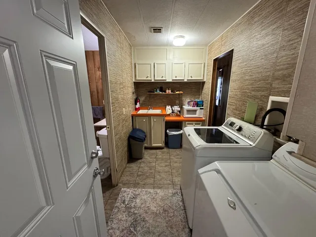 a bathroom with a sink a toilet and shower curtain