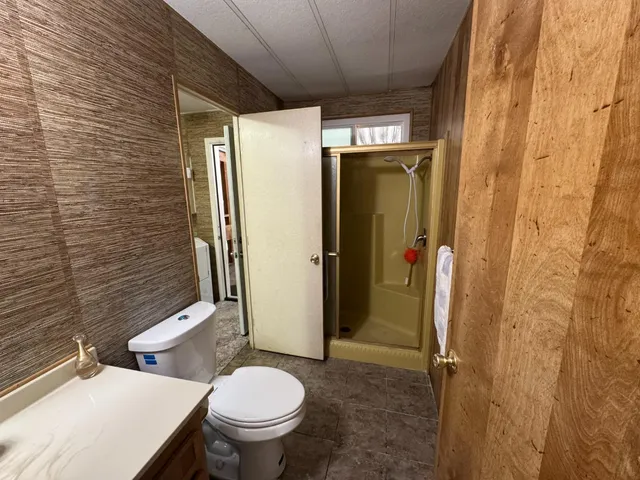 a bed room with a bed and a chair