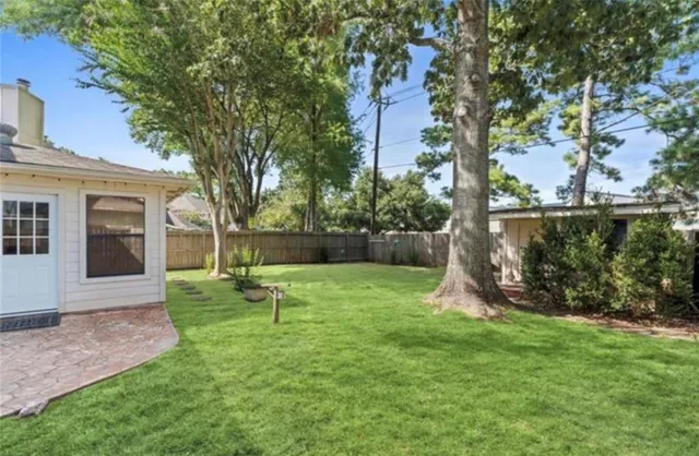 a green field with lots of trees in it