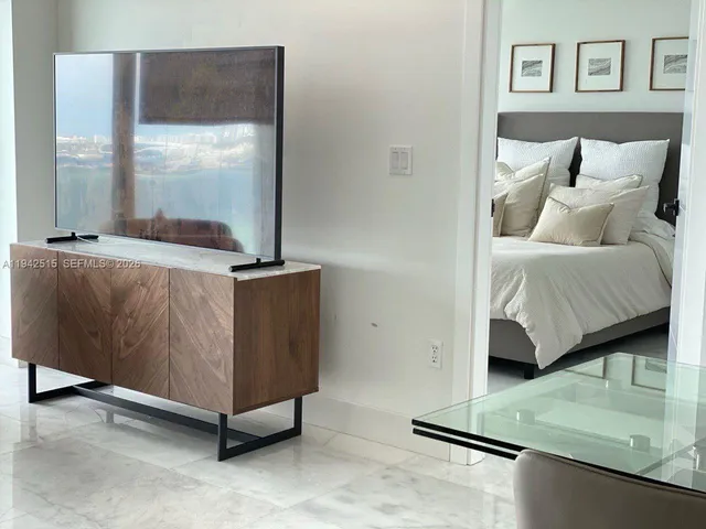 a bedroom with a bed and cabinets