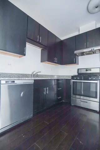 a kitchen with granite countertop a stove and a sink