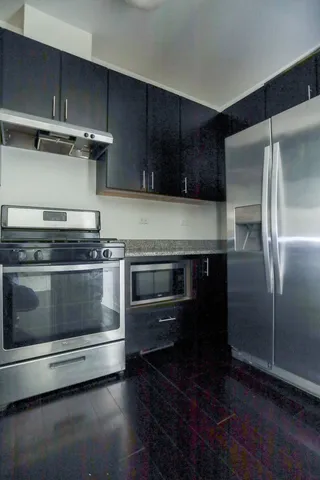 a stove top oven sitting inside of a kitchen