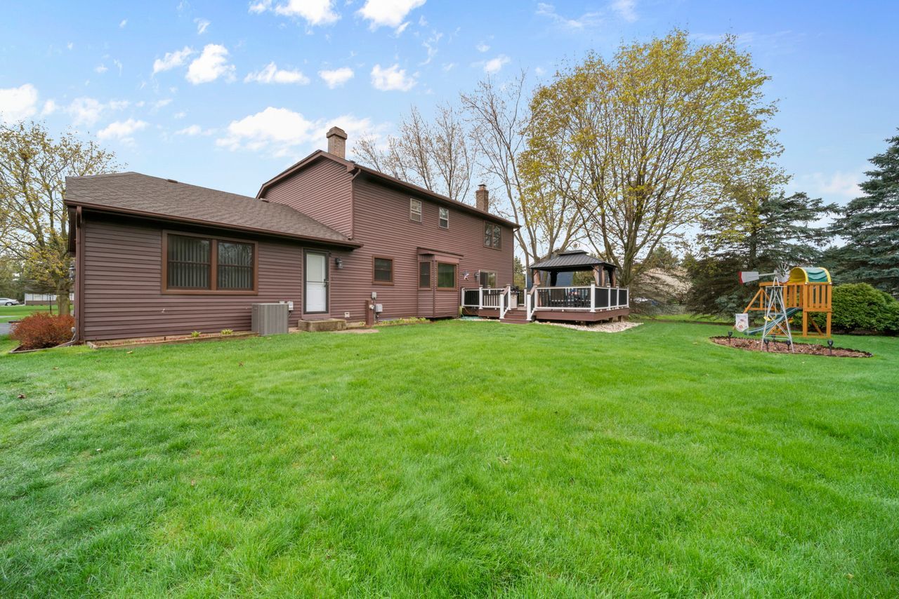 1908 Spring Dale Drive Spring Grove, IL 60081 - Photo 16 of 17 a view of a house with a yard and sitting area