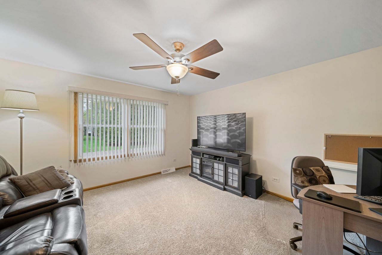 1908 Spring Dale Drive Spring Grove, IL 60081 - Photo 9 of 17 a living room with furniture a ceiling fan and a window