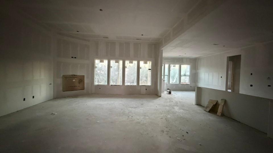 907 Perrin Lane Van Alstyne, TX 75495 - Photo 3 of 7 a view of an empty room with a fireplace and a window