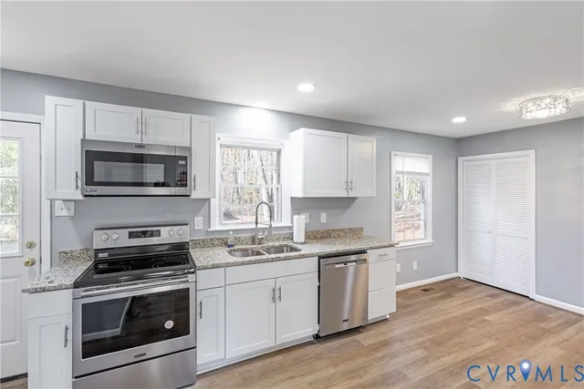 a kitchen with a sink stove and microwave