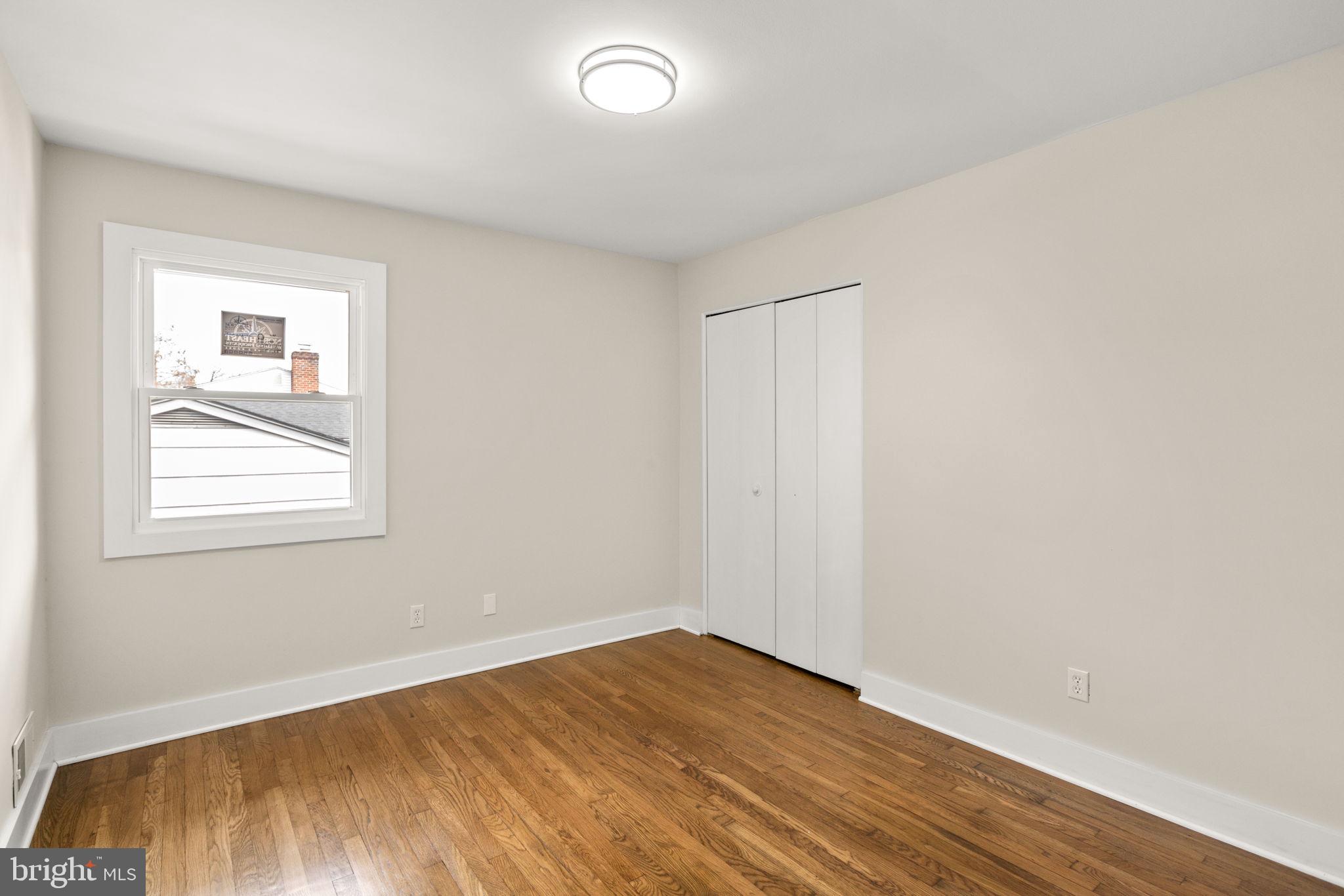 3908 Rayton Road Randallstown, MD 21133 - Photo 18 of 42 an empty room with wooden floor and windows