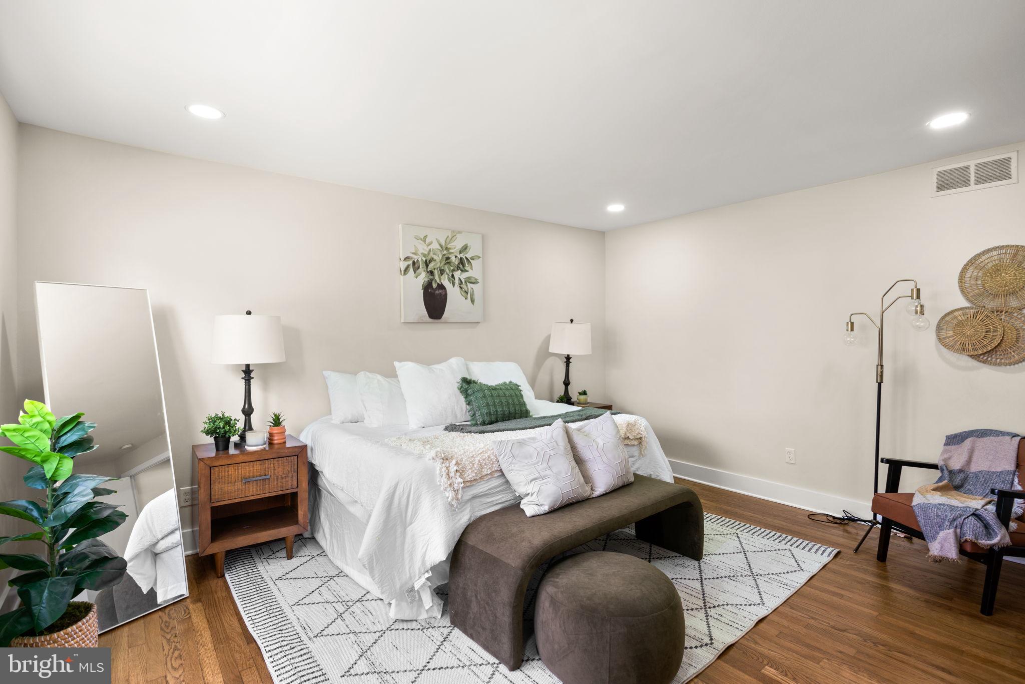 3908 Rayton Road Randallstown, MD 21133 - Photo 23 of 42 a bedroom with a bed and a potted plant