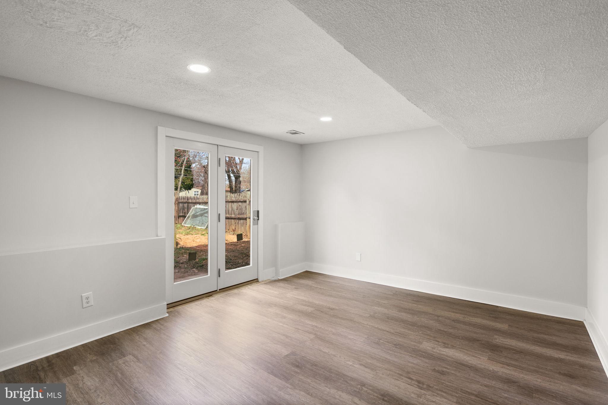 3908 Rayton Road Randallstown, MD 21133 - Photo 28 of 42 a view of an empty room with wooden floor and a window