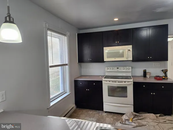 a kitchen with a stove and a refrigerator