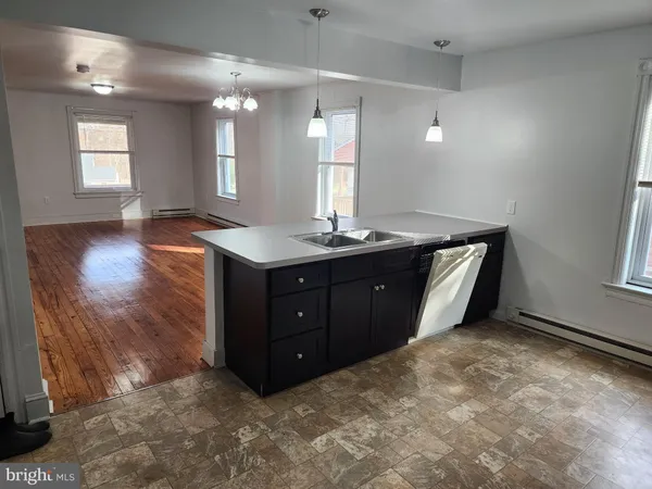 a spacious bathroom with a granite countertop sink a mirror and vanity