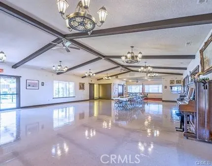 a view of a room with lots of dining room and chandelier