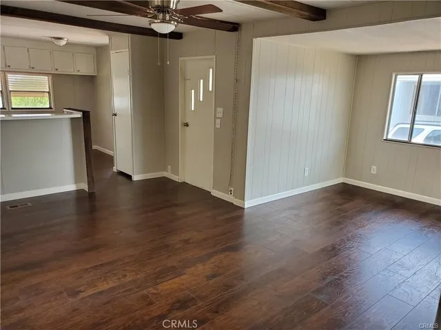 an empty room with wooden floor and a window