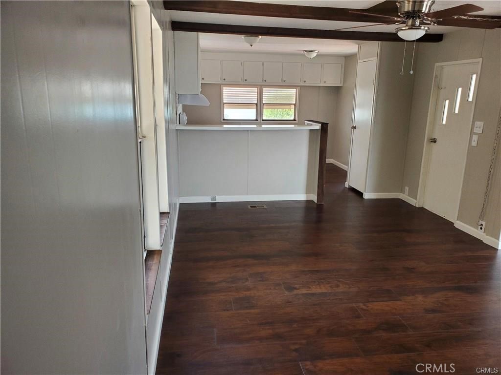 2240 Golden Oak Lane, Unit 132 Merced, CA 95341 - Photo 4 of 13 a view of a hallway with wooden floor and a cabinet