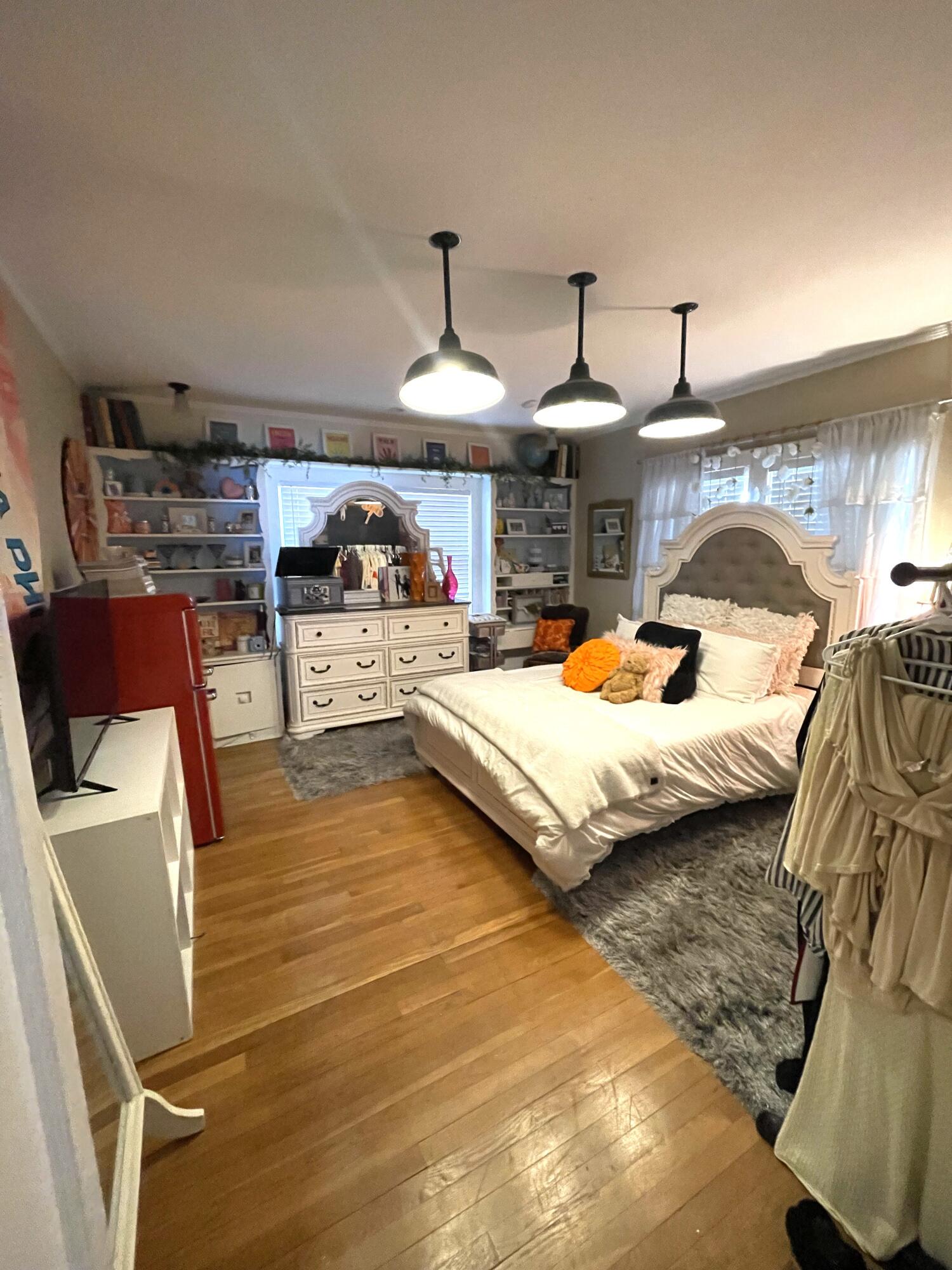 2315 16th Street Lubbock, TX 79401 - Photo 15 of 20 a bedroom with furniture and a chandelier